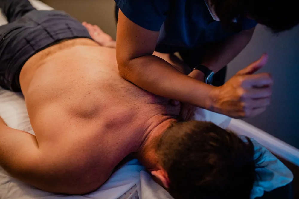 Patient receiving a chiropractic spinal adjustment on a chiropractic table
